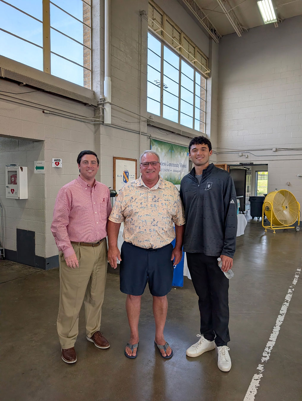 From left, Daviess Community Hospital CEO Justin D. Harris, MSHA, MBA, FACHE, and DCH Board of Governors President Deron Steiner stand with former Indiana University basketball player Anthony Leal who attended the Hoops for Healthcare event, connecting with attendees and adding to the excitement of the day.