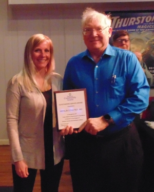 two people holding an award