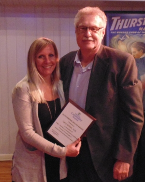 two people holding an award